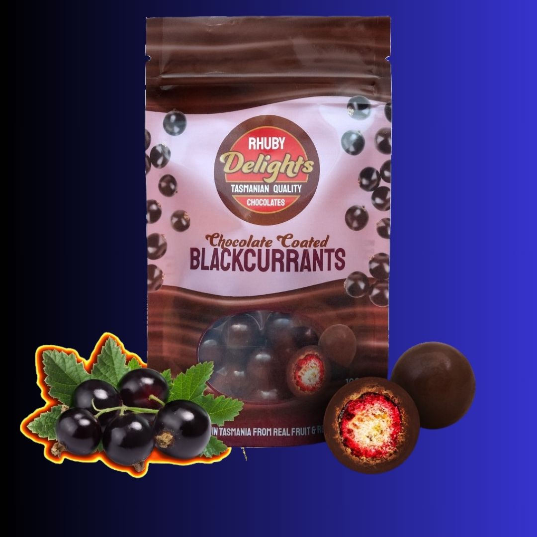 a bag of chocolate covered cherries next to a bunch of cherries