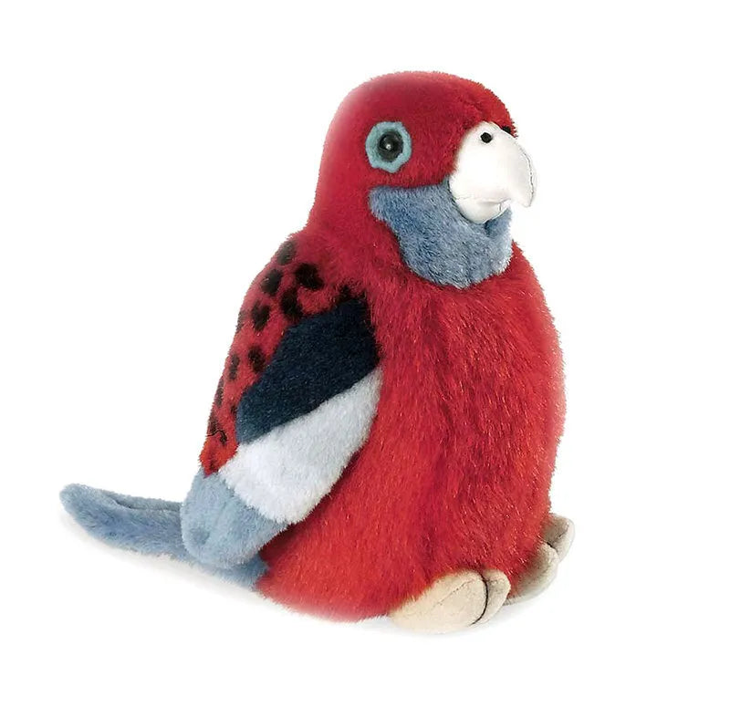 a red bird sitting on top of a white floor