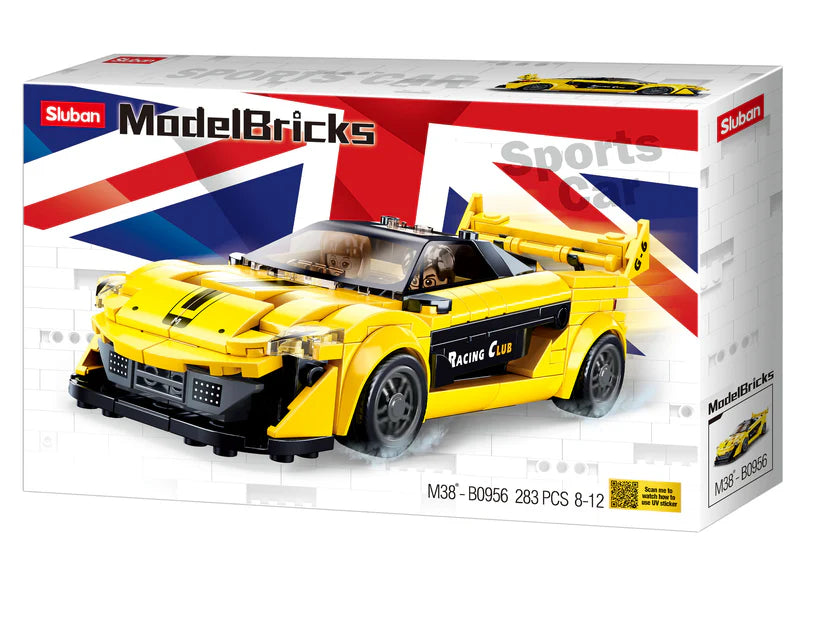 a yellow model car in a box on a white background