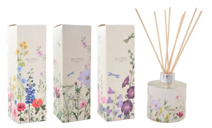 a white box with a floral design and a reed in it
