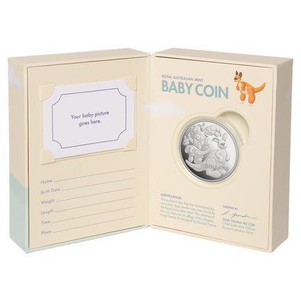 a baby coin in a box with a note inside
