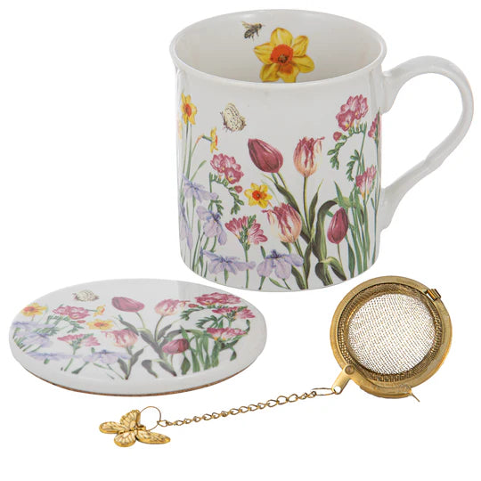 a coffee cup with a tea strainer next to it
