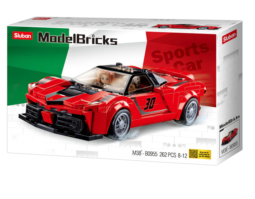 a red toy car in a box on a white background