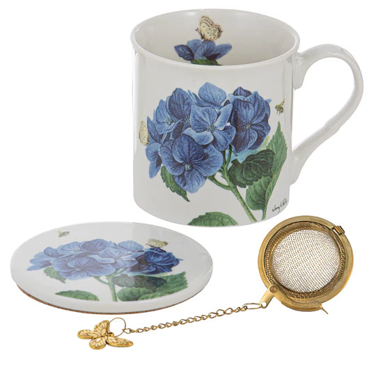 a coffee cup with a tea strainer next to it