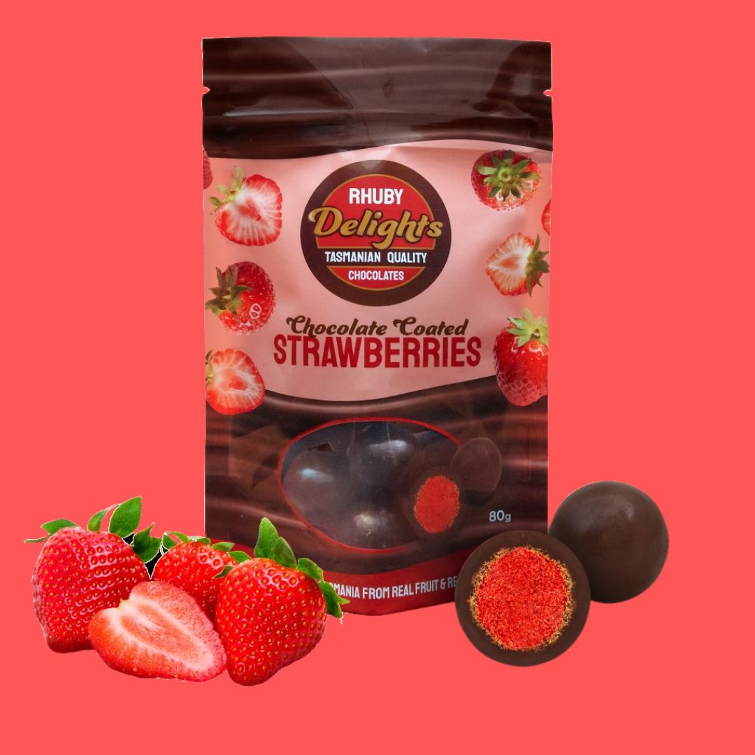 a bag of chocolate covered strawberries next to some strawberries
