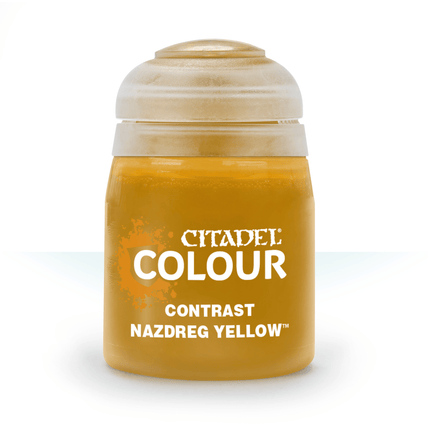 a bottle of yellow paint sitting on top of a table